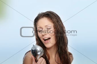 Young woman singing under shower