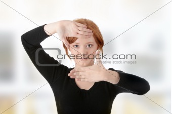 Young attractive woman framing her hands