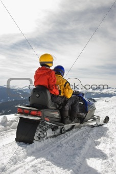 Couple on snowmobile.