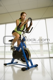 Woman exercising on bike.
