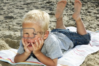 Boy Lying On A Beach