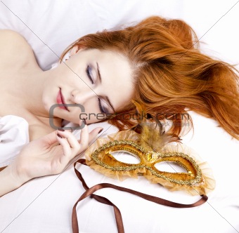 Sleeping woman near carnival mask.