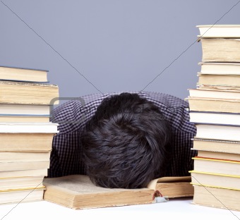 The young tired student with the books isolated.