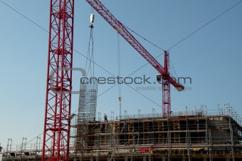 Construction site with cranes and building