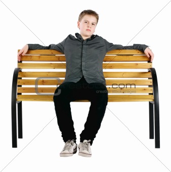 Relaxed boy sitting on bench