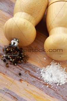 Wooden salt and pepper pot over wooden  background