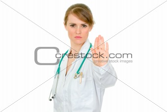 Strict medical female doctor showing stop gesture
