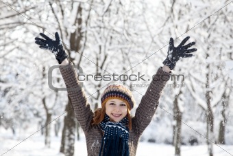 Beautiful young red-haired woman in winter park 