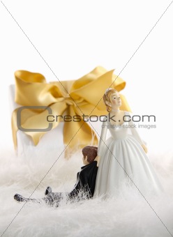 Wedding cake figures with gift on white