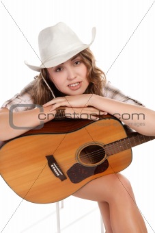 cowgirl in cowboy hat with acoustic guitar