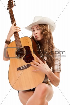 cowgirl in cowboy hat with acoustic guitar