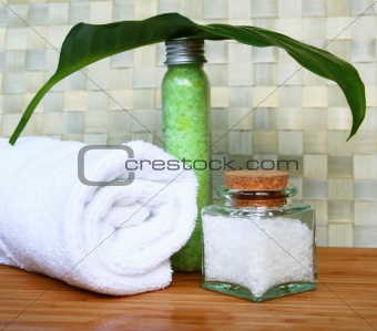 White bath towel, bottle of sea salt in spa composition