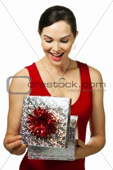 Attractive young woman looking in a gift box