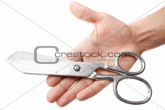Scissors in a hand of the tailor