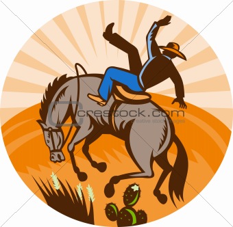 cowboy falling off horse in the desert 