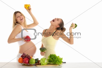 Two women dance with fruits and vegetables