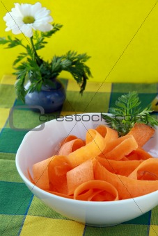 Carrot salad in white bowl  wiath basil