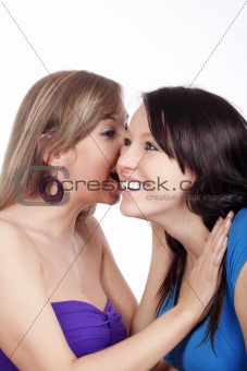 two young woman whispering gossip - isolated on white