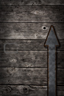 rusty arrow on wooden background