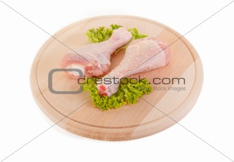 Fresh raw chicken legs on wooden board 