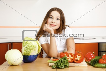 beautiful caucasian woman preparing salad in the kitchen.