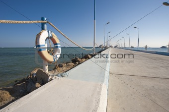 Long concrete jetty with boats