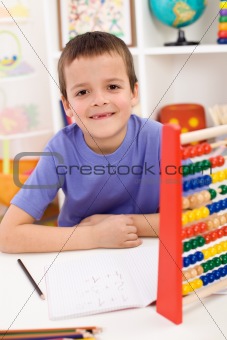 Happy kid solving math exercise