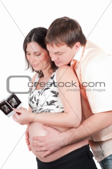 Couple holding a sonogram of their child