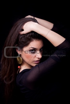 Young woman posing, on black background