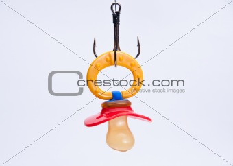 infant pacifier hangs on a hook