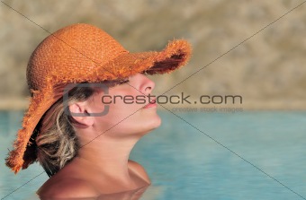 Young woman enjoying the sun in the pool