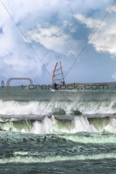 many surfers windsurfing in a storm