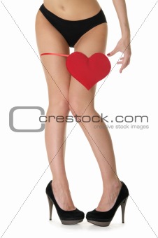 heart at the foot of woman in black lingerie