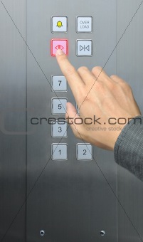 businessman hand press open door button in elevator