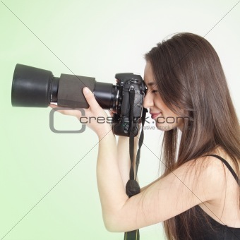 a young female photographer with a professional camera 