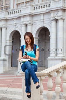 Young woman texting on campus