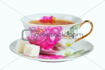 A cup of tea and sugar in isolation on a white background