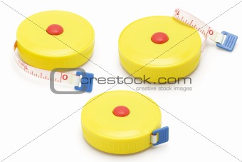 Three yellow plastic measuring tapes
