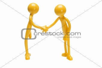Toy rubber figurines shaking hands