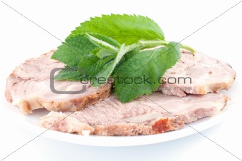 Cold boiled pork decorated with fresh green spearmint