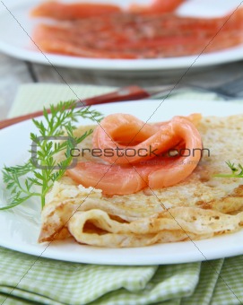salted salmon red fish with pancakes on a plate