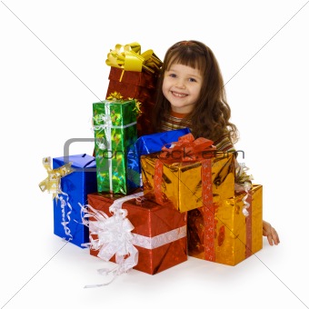 Happy child and big heap of gifts