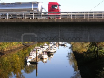 Truck on a road above a boat canal in Oldenburg 