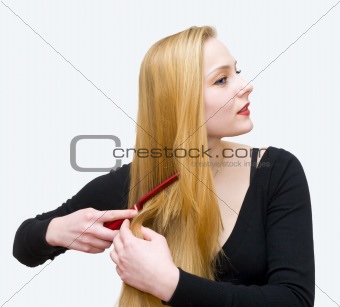 young girl combs hair