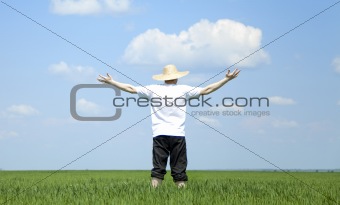 Farmer in hat at spring field.