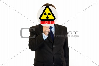  radiation danger! Businessman holding  radiation sign in front of face
