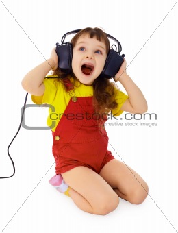 Cheerful little girl sings the music
