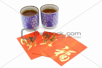 Chinese prosperity tea cups and red packets 