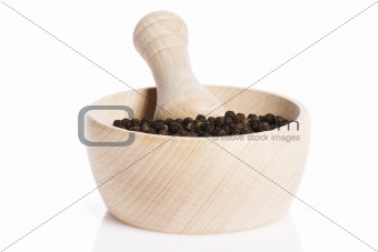 peppercorns in a wooden mortar