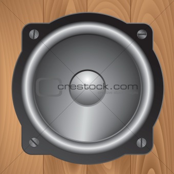 Audio speaker on wooden background